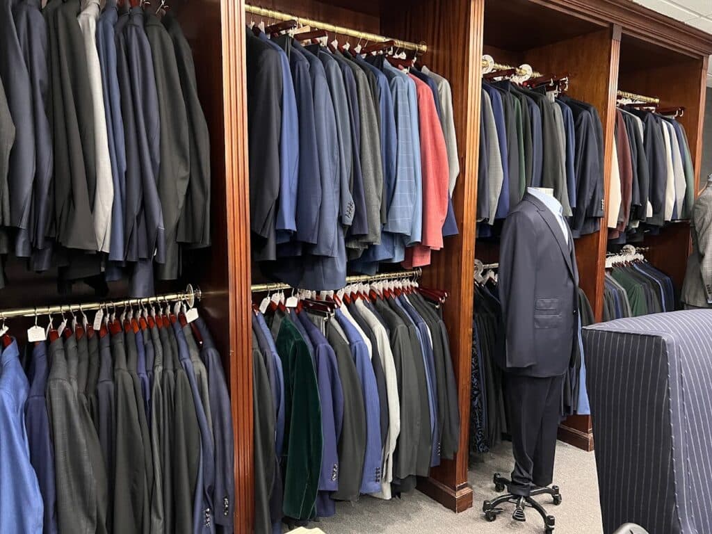 Inside of a custom tailor store with jackets hanging 