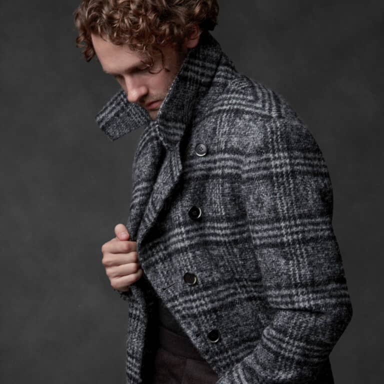 Client wearing custom made double breasted grey plaid overcoat.