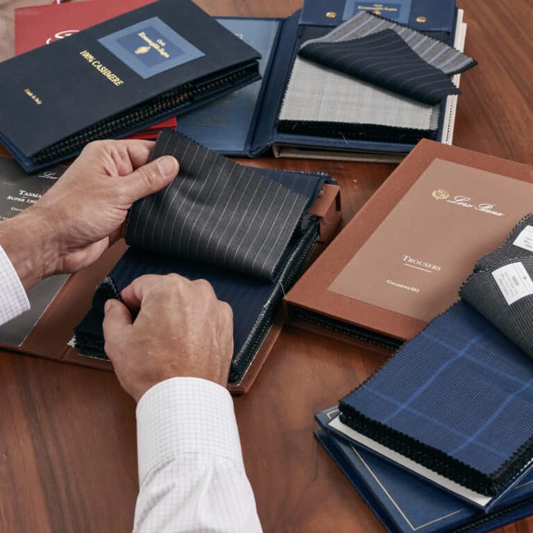 Client looking thru Loro Piana fabric swatches.