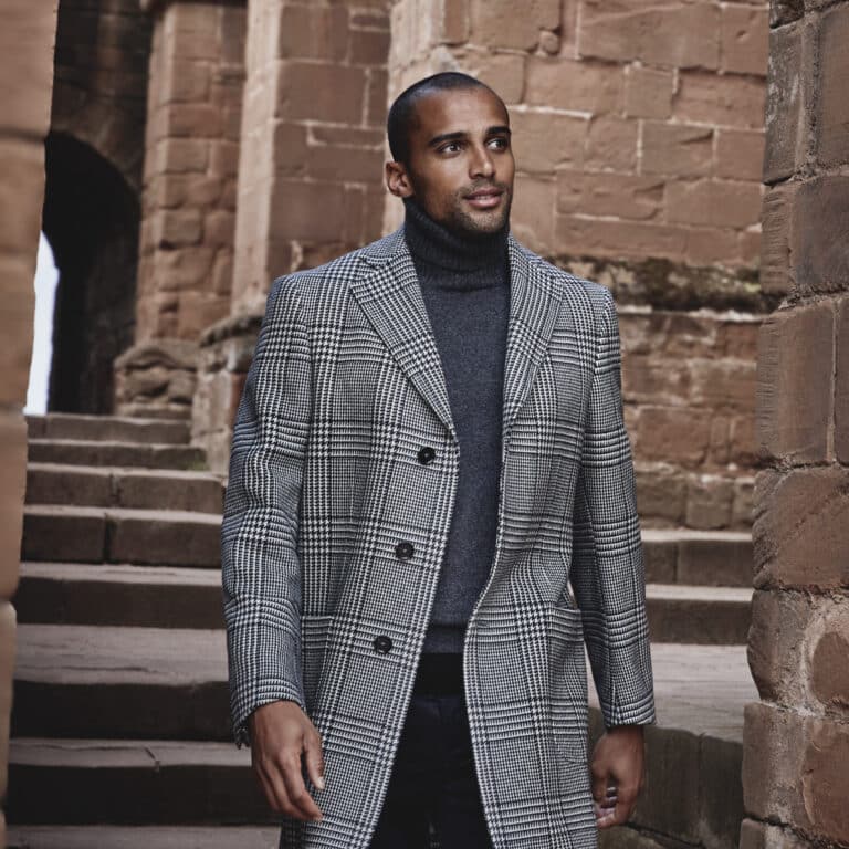 Model in double breasted prince of wales black and white plaid bespoke overcoat