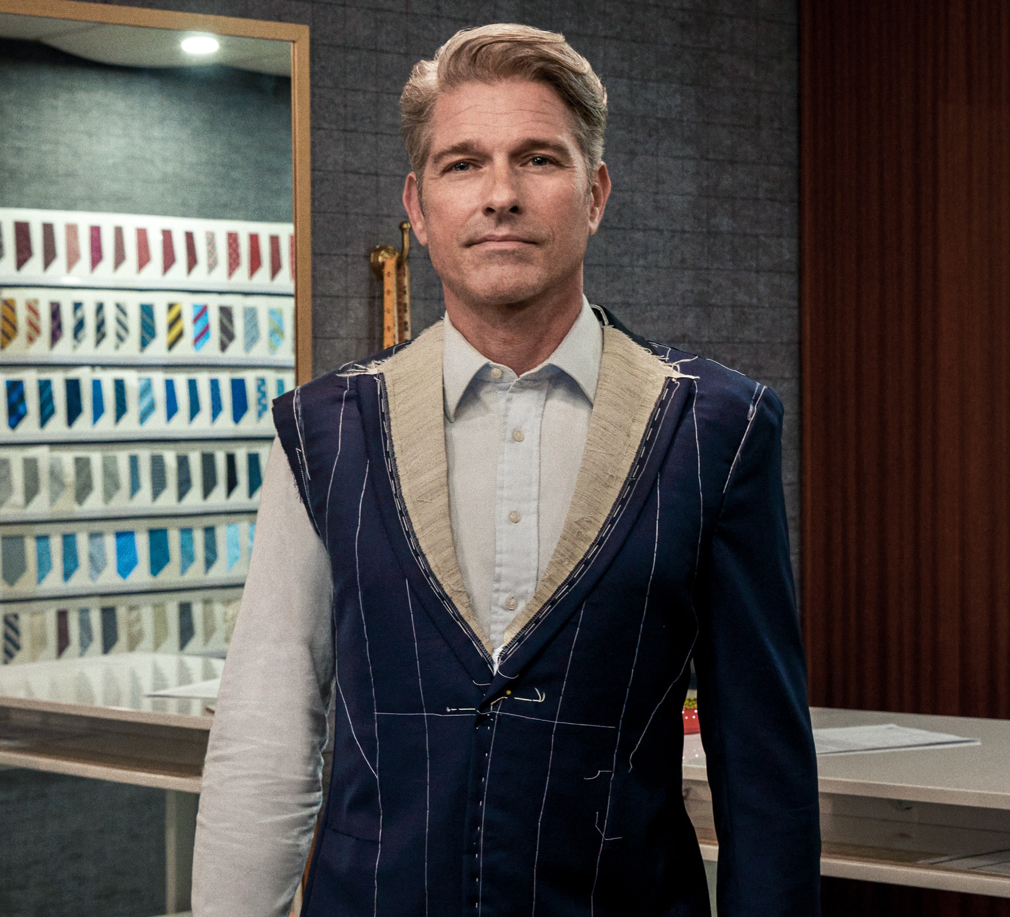 Client wearing a basted fitting bespoke jacket with canvas exposed