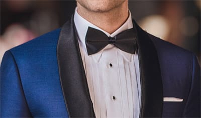 Loro Piana blue custom wedding tuxedo with black shawl collar, white shirt and black bowtie.