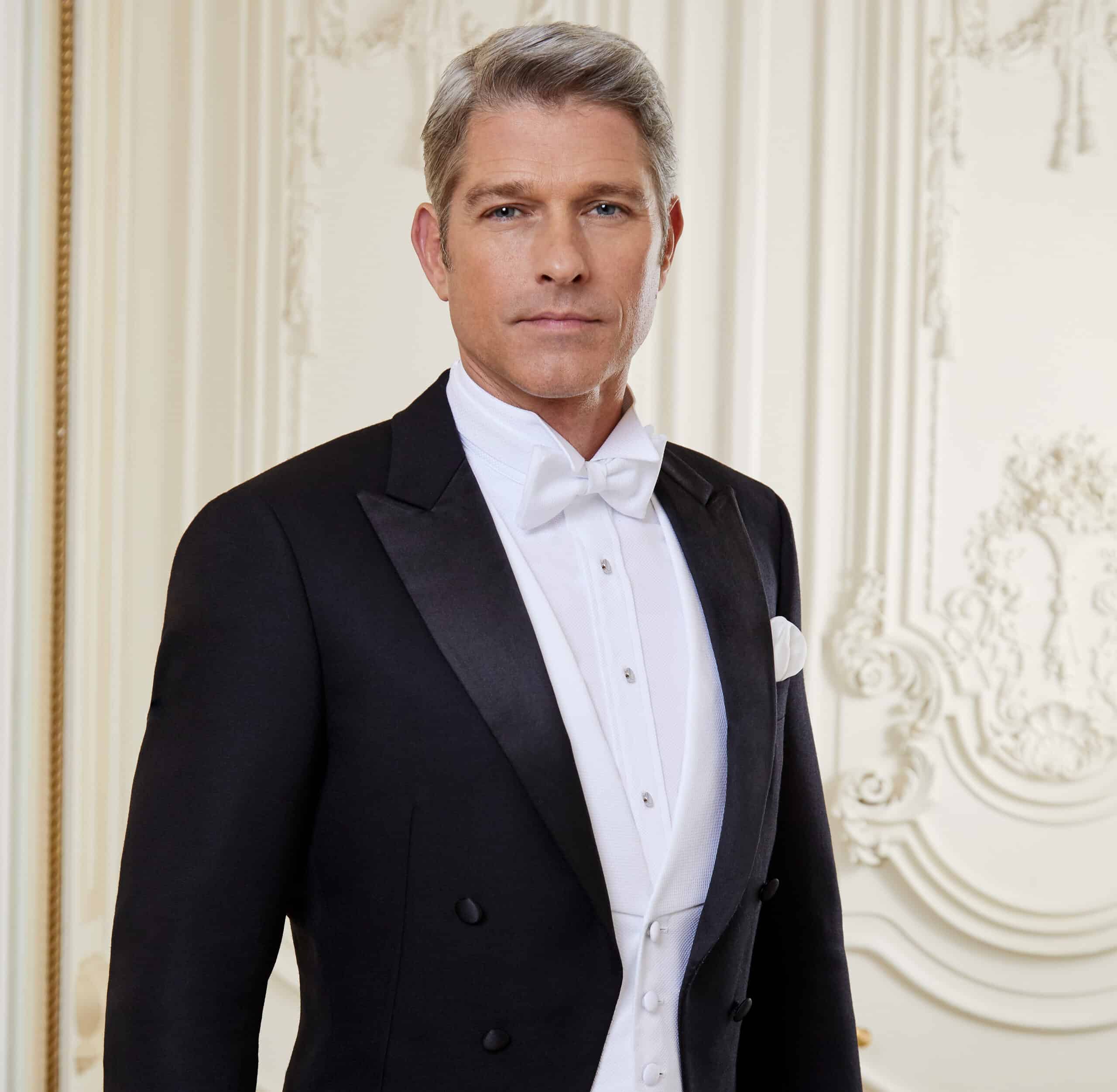 Model wearing bespoke full dress tails with white vest, white shirt and white bowtie. Fabric by Loro Piana.