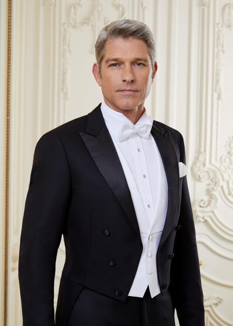 Model wearing bespoke full dress tails with white vest, white shirt and white bowtie. Fabric by Loro Piana.
