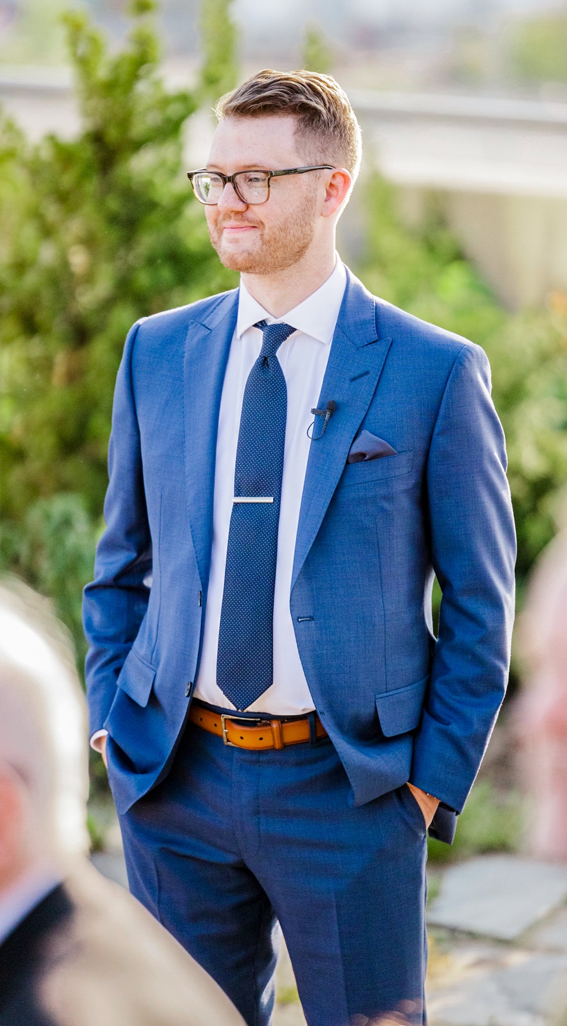 Groom outdoors wearing a blue Ermenegildo Zegna custom suit with a white shirt and a blue tie.