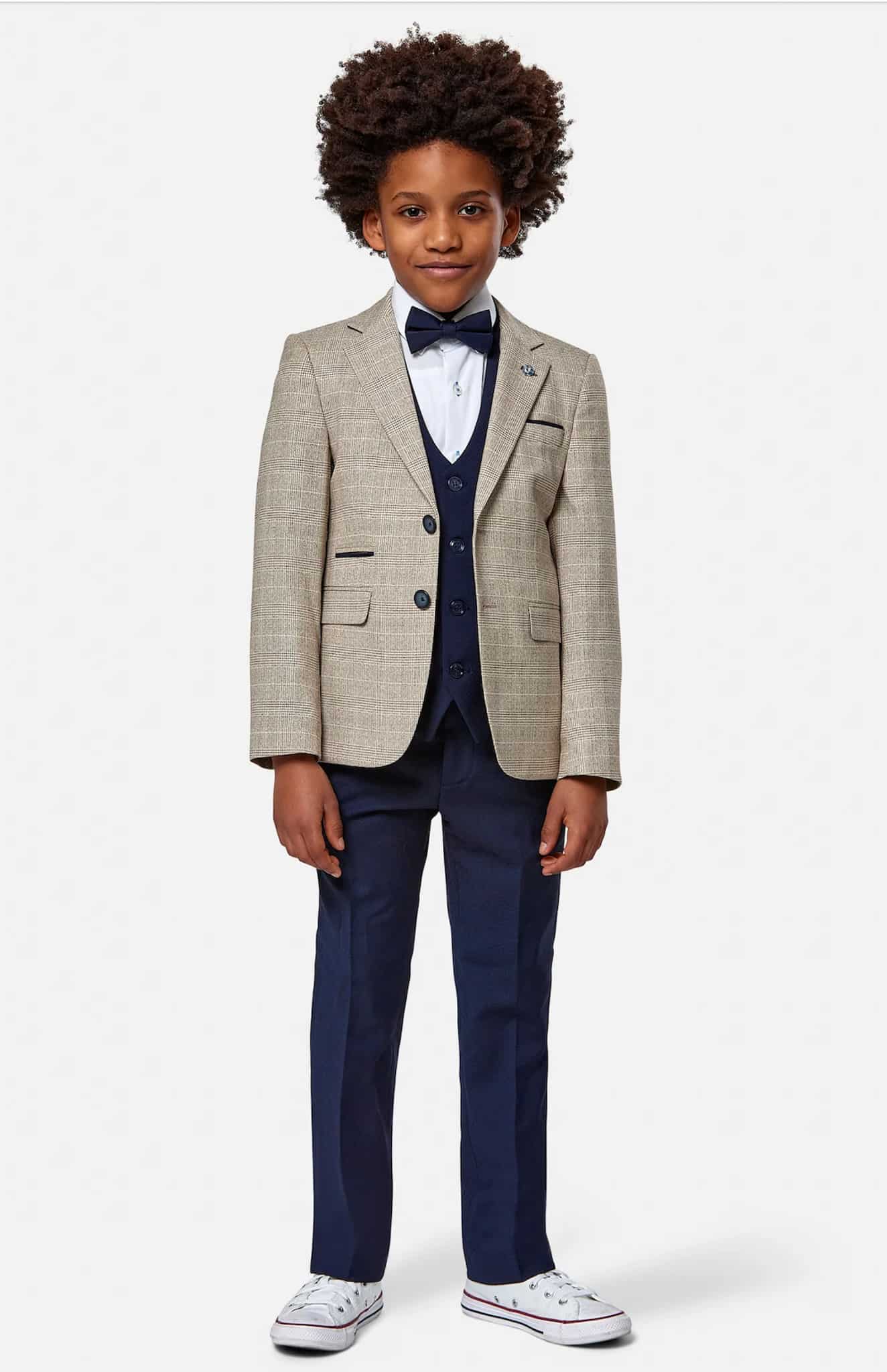 Boy in light green windowpane boys custom tailored sportscoat and black trousers and black vest.