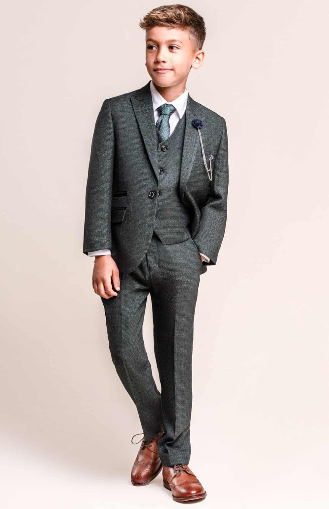 Boy in grey vested bespoke suit.