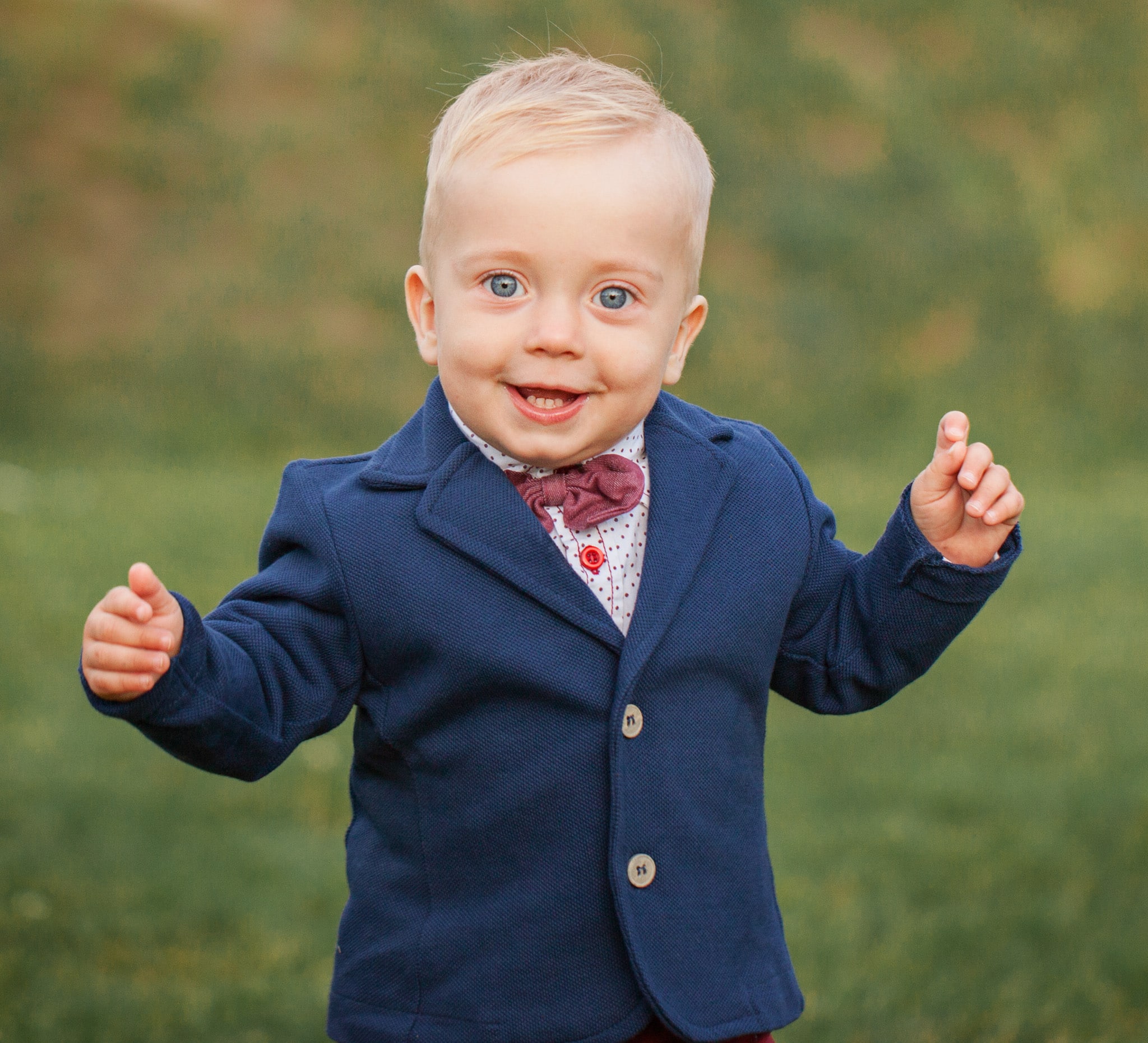 Little boy in blue custom suit with white shirt.
