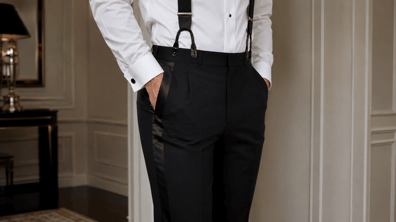 man wearing a tuxedo pants with satin stripes and braces