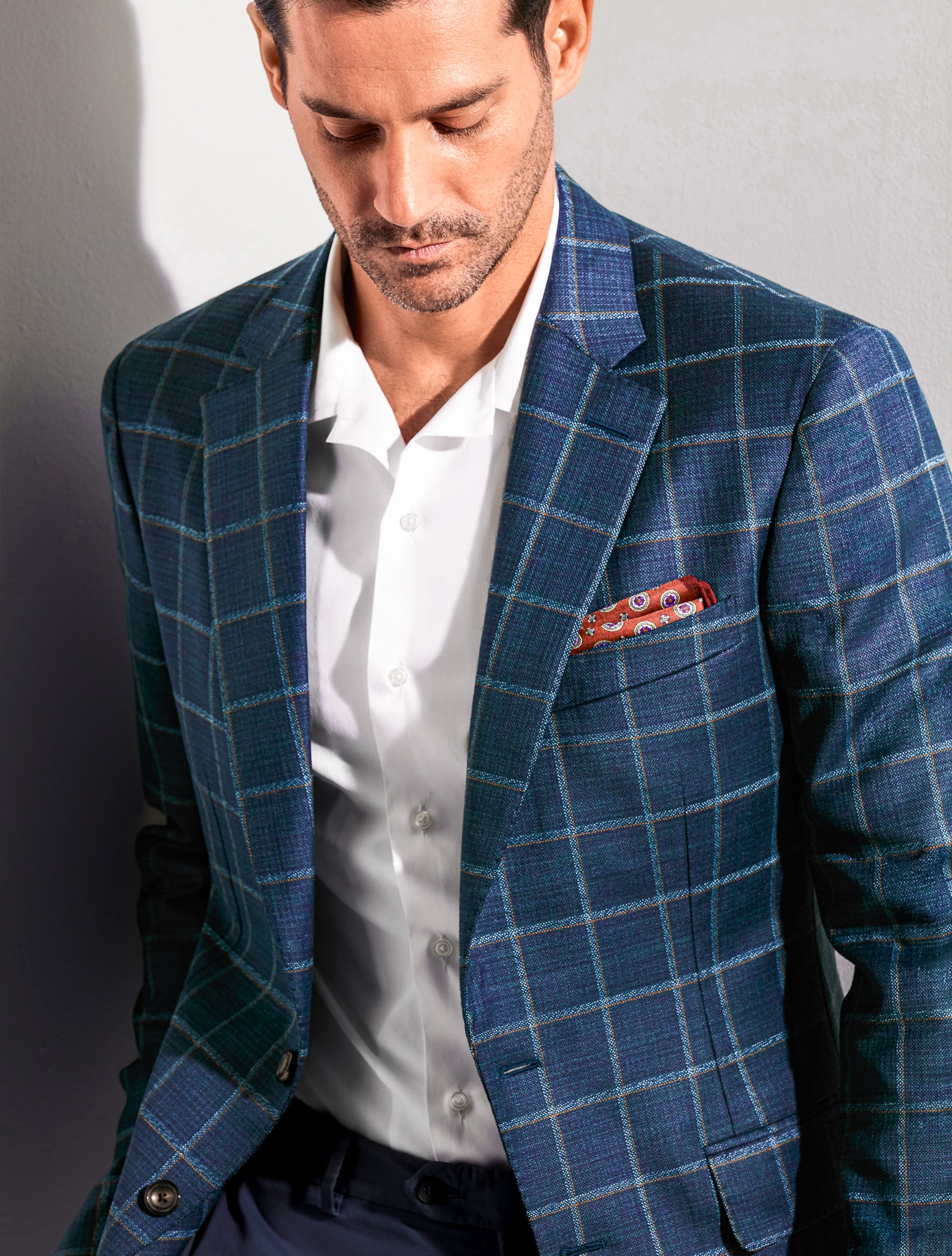 Client wearing navy custom sportscoat with white windowpane from Loro Piana with white open collared custom dress shirt.