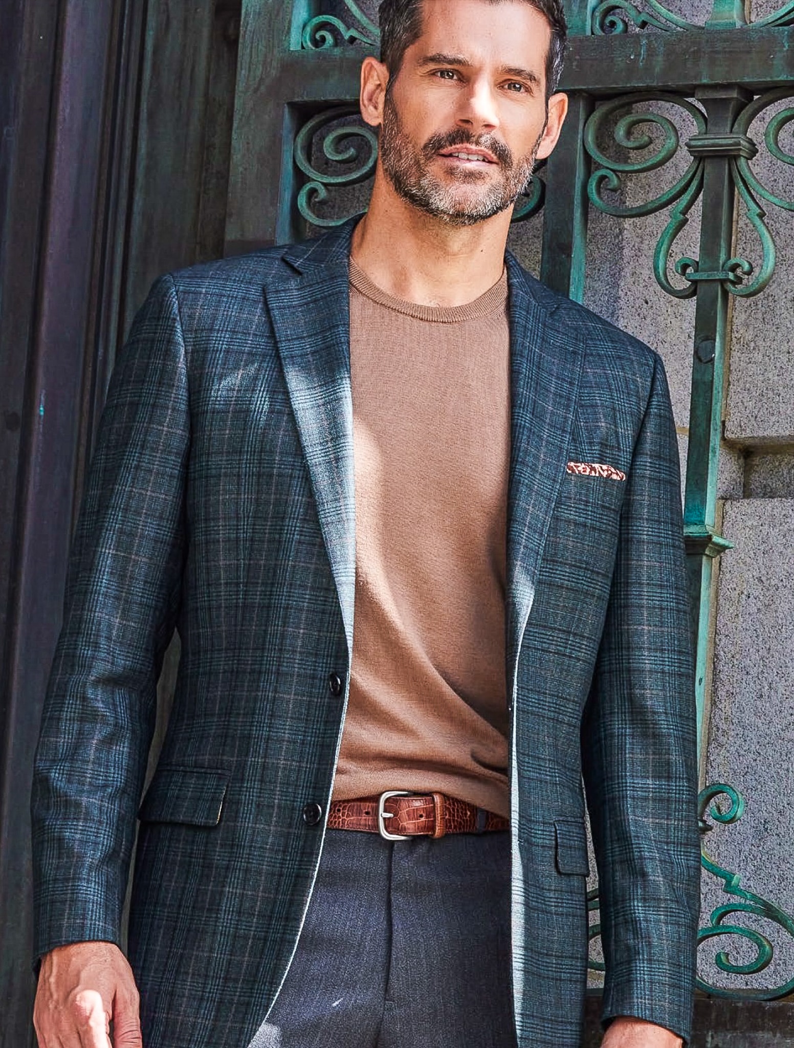 Client wearing blue plaid custom made sportscoat with brown mock neck polo. Fabric is bamboo made by Holland & Sherry.