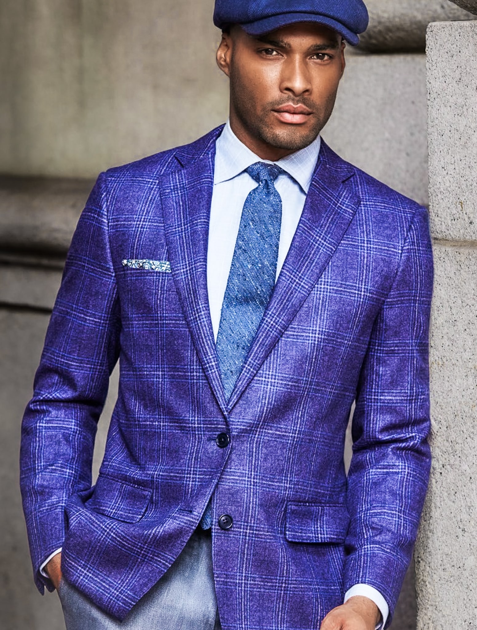 Client in light blue custom sportscoat with large white double windowpane pattern and pale blue dress shirt with long tie in solid blue color. Fabric by Drago.