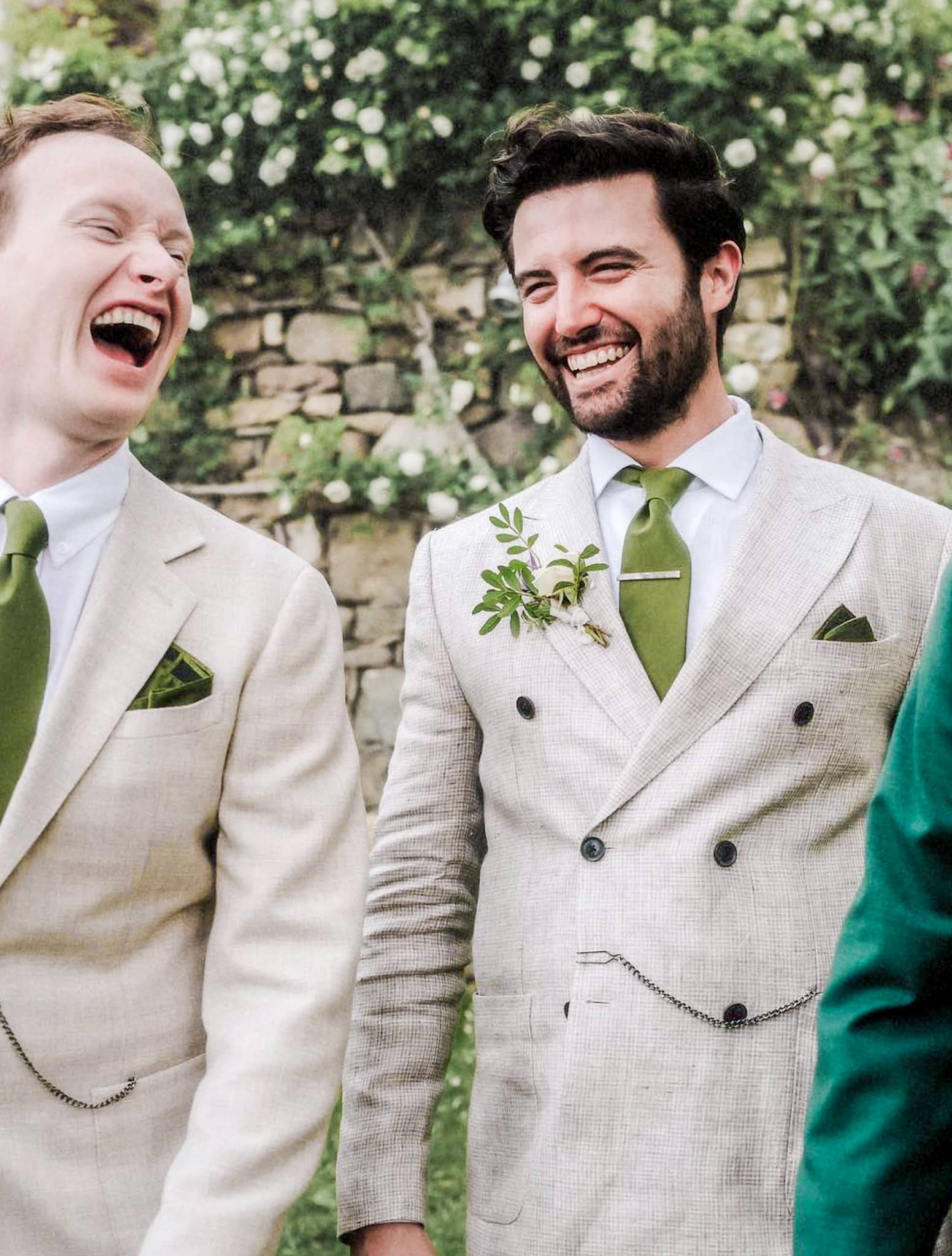 Groom and groom both wearing cream color bespoke wedding suits. One high double breasted six on two and one single breasted vested.