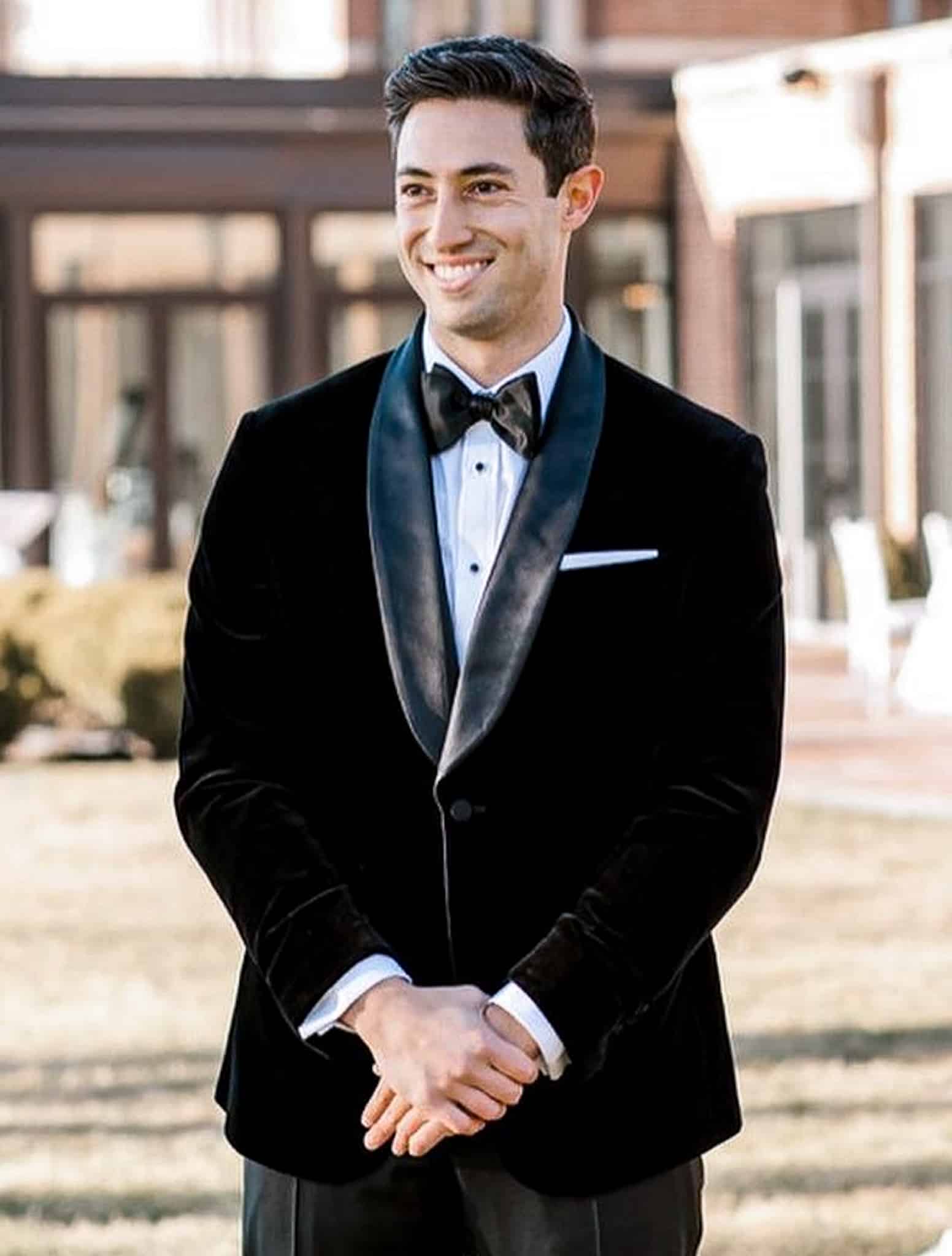 Groom in Loro Piana basic black custom made tuxedo with white shirt and black bowtie.
