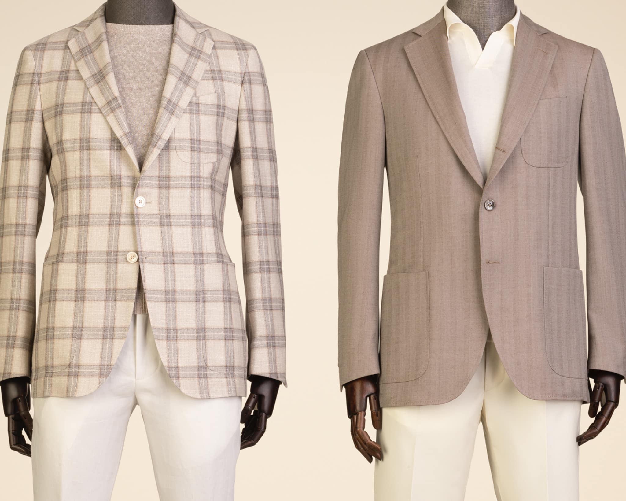 Two mannequins one off white sportscoat with light grey plaid and white pants. Other Brown sportscoat 2 button with patch pockets, off white pants.