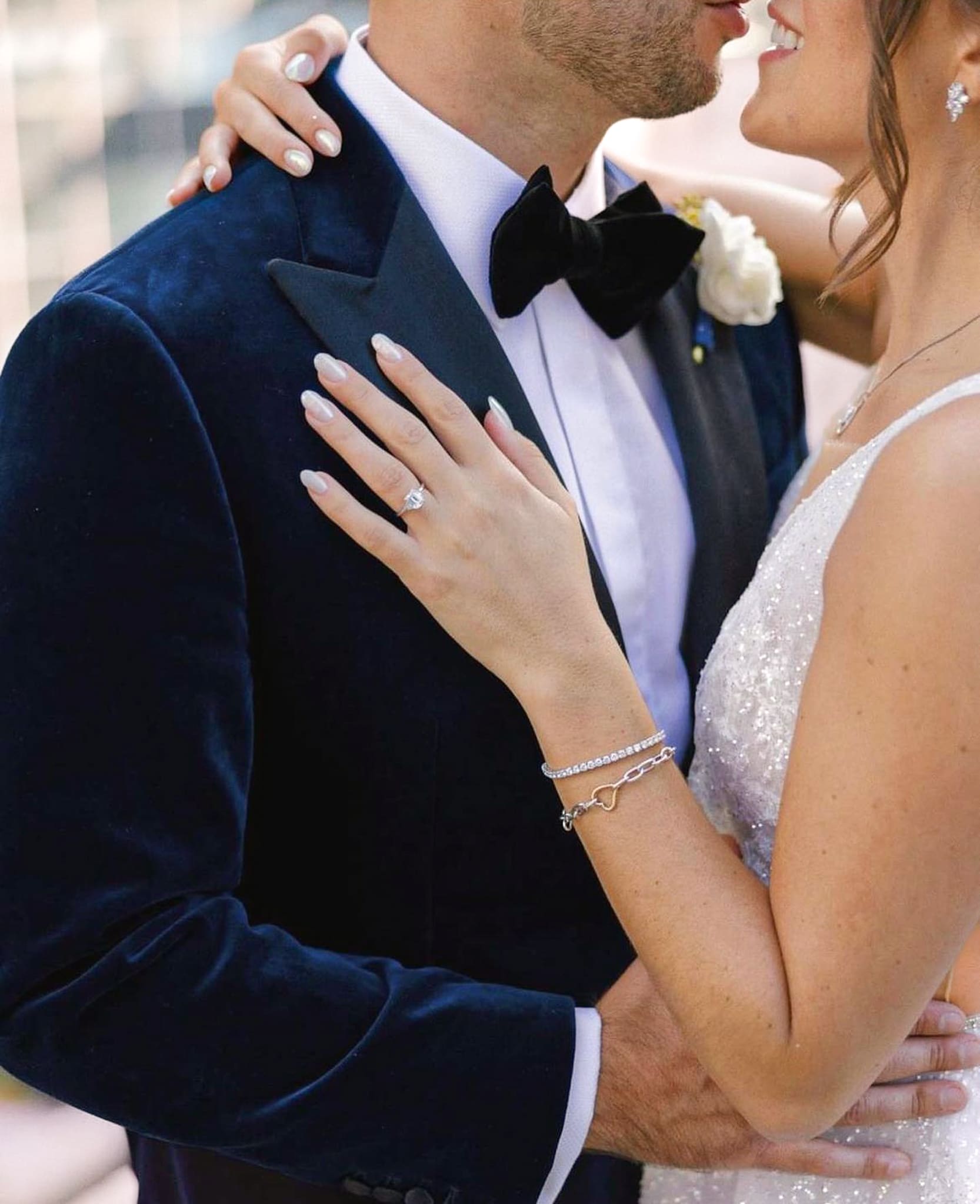 Bride dancing with groom. Groom wearing Scabal velvet bespoke wedding suit. Bride in sleeveless wedding dress.