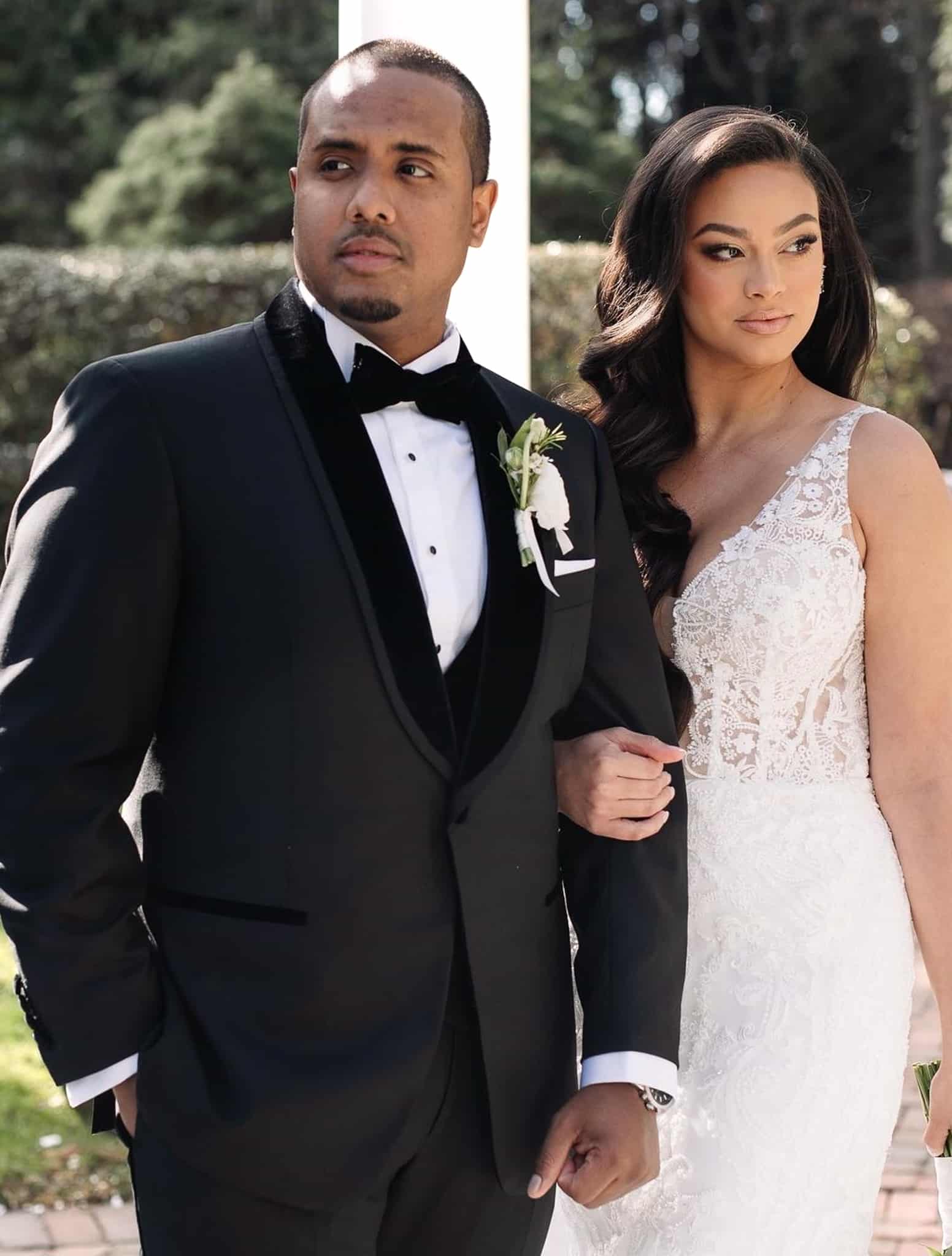 Bride and groom outdoors. Groom wearing Zegna three piece custom wedding tuxedo with white shirt and black bowtie.