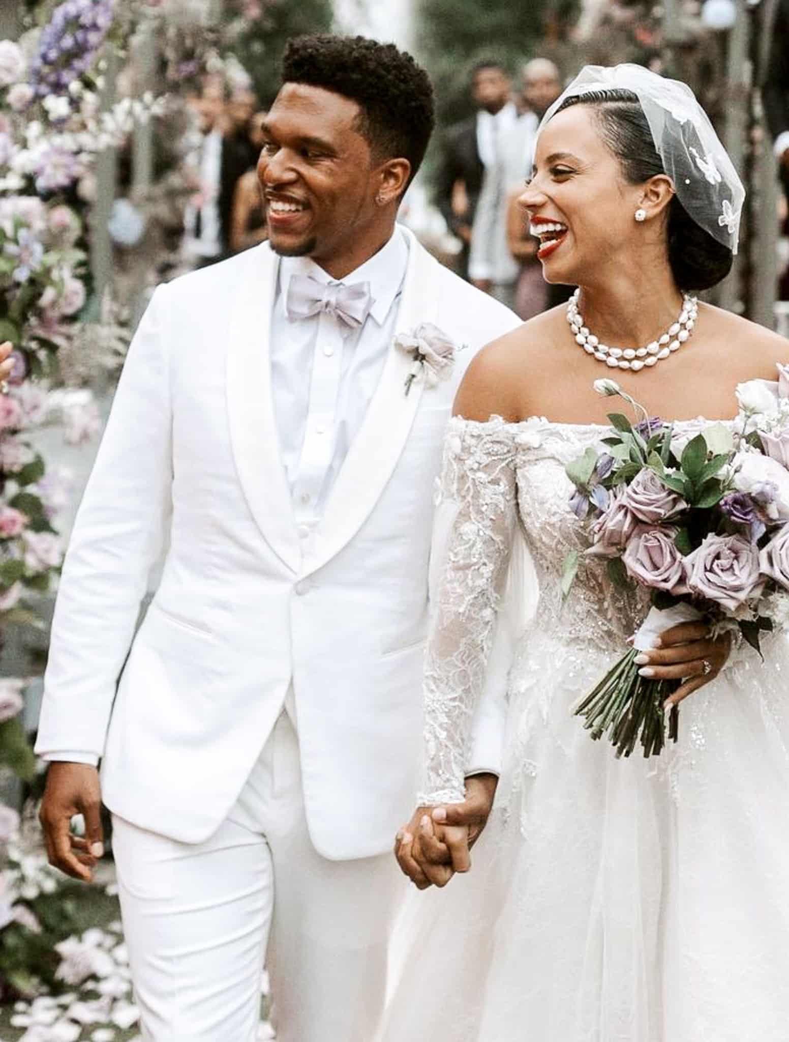 Bride and groom, groom in white cotton custom tailored wedding suit with shawl lapel, white shirt and white bowtie. Bride in classic wedding dress.