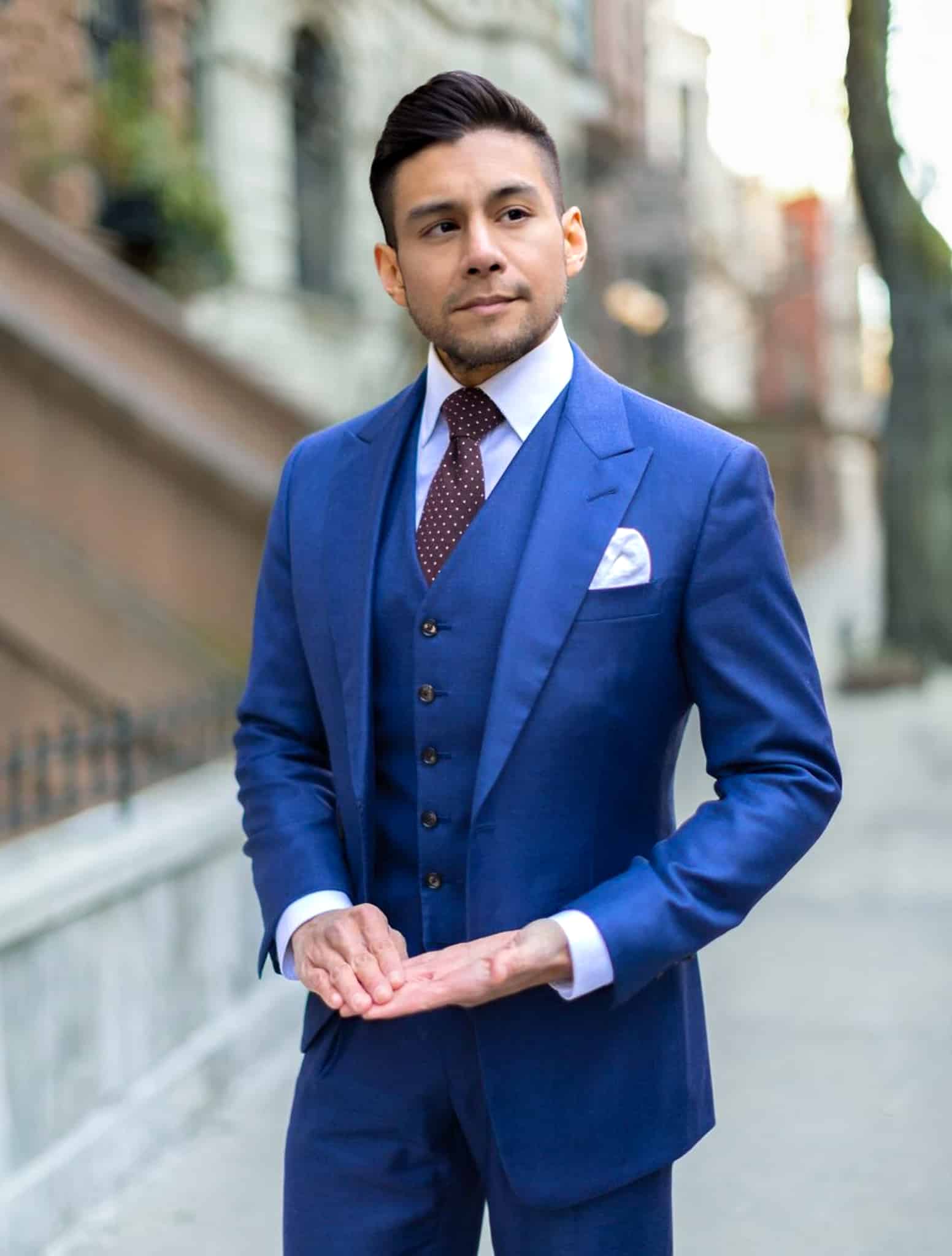 Groomsman in french blue solid bespoke suit with matching vest, white shirt and red polka dot tie. Suit fabric by Loro Piana.