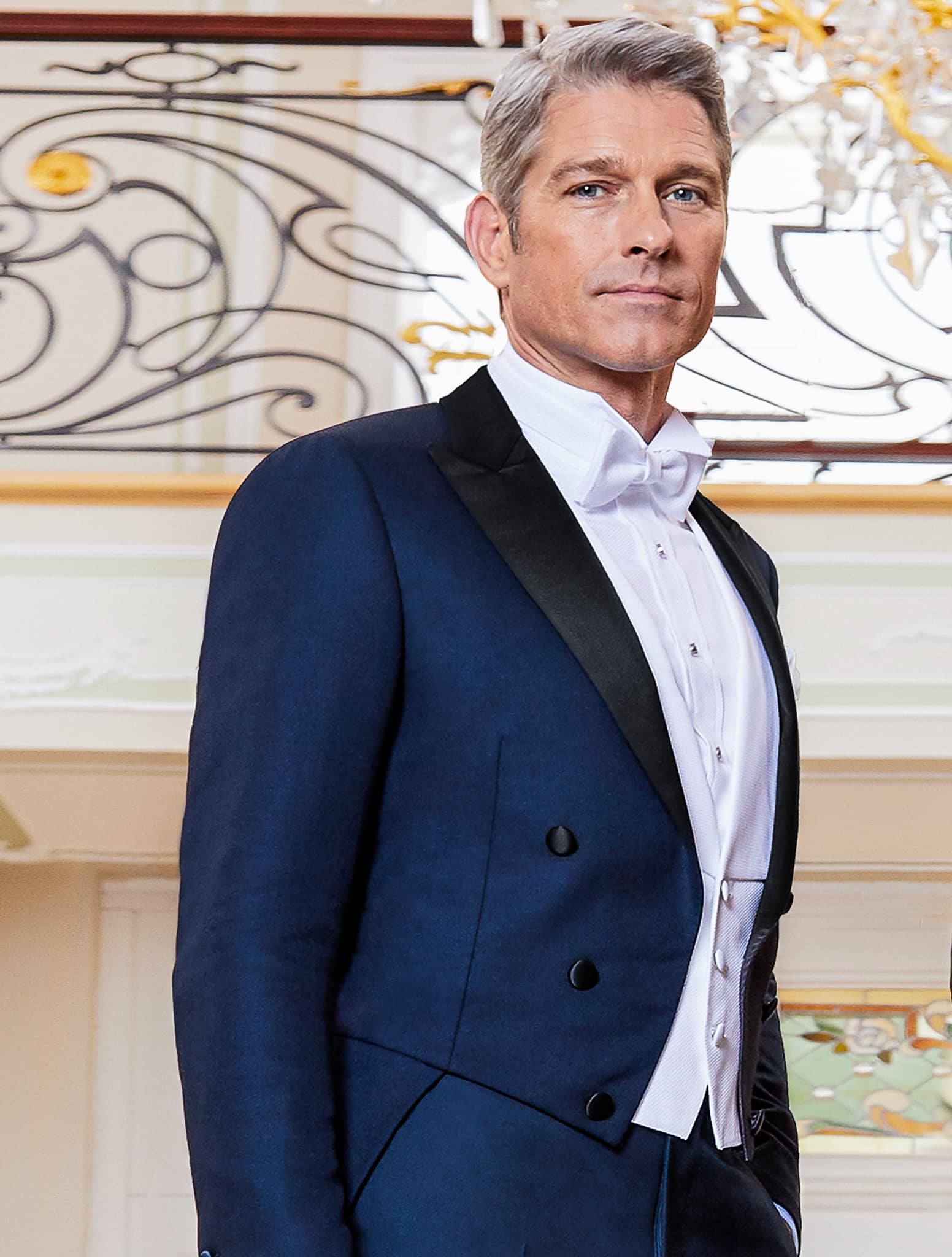 Groom in navy custom made full tails and peak lapel with white pique vest.