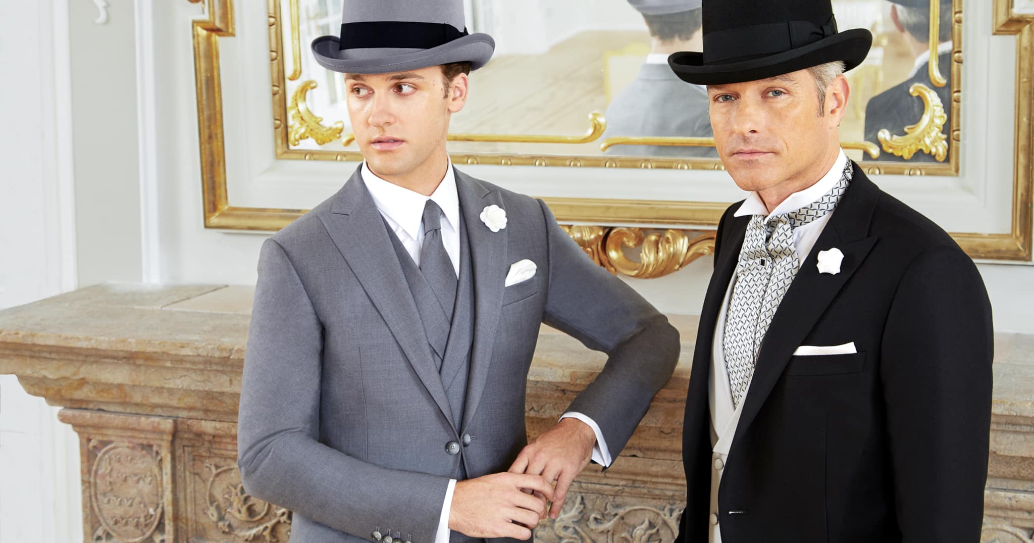 Groom and best man in bespoke formal wedding suits. Groom wearing custom full dress tails with white vest and grey ascot. Best man in solid grey bespoke morning suit with matching double breasted vest.
