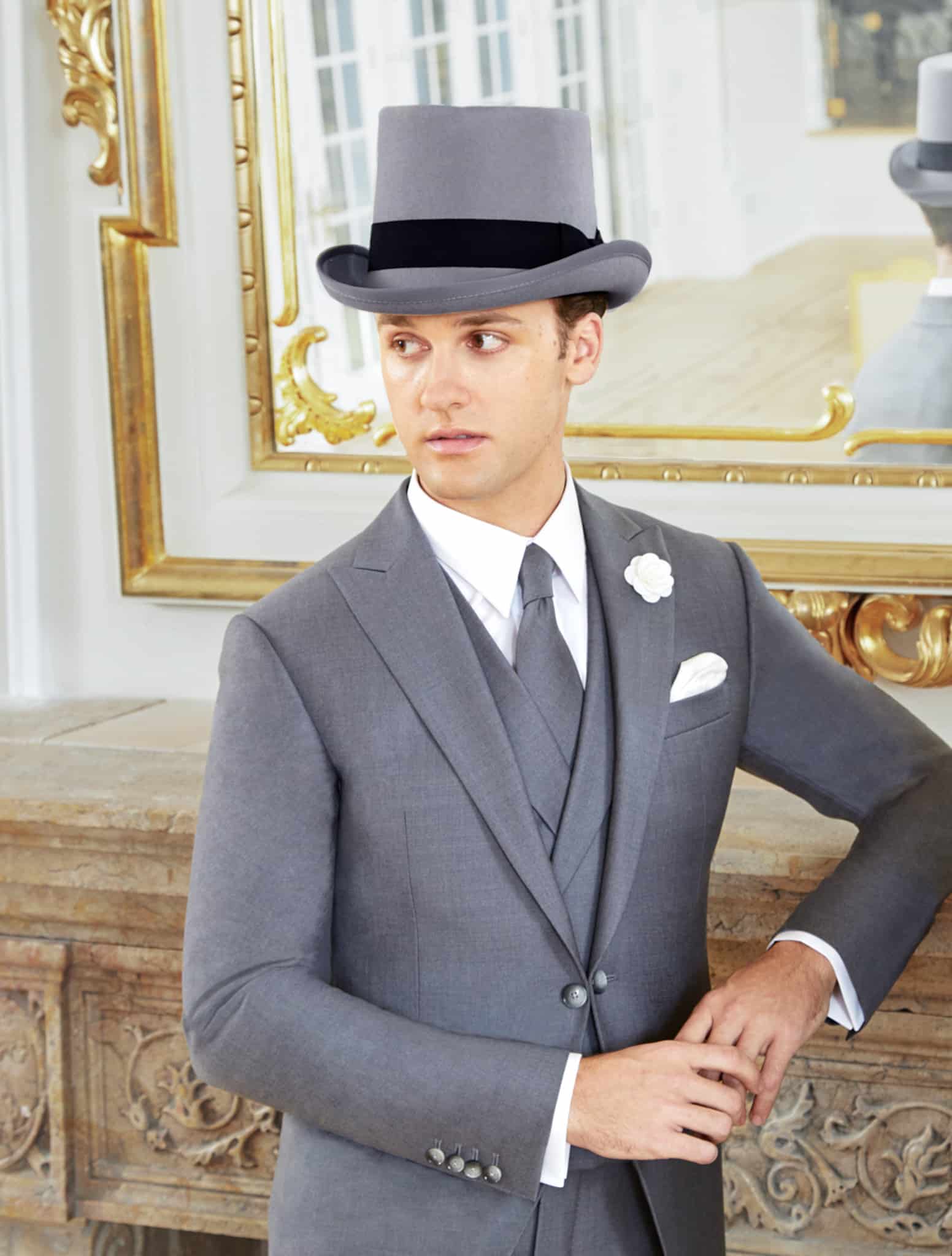 Groom wearing custom full dress tails with white vest and grey ascot.